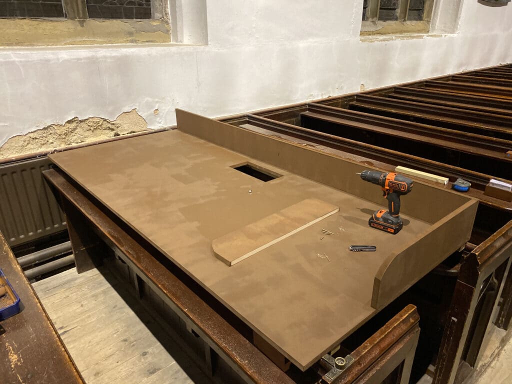 A partially assembled desk in-situ in its final location